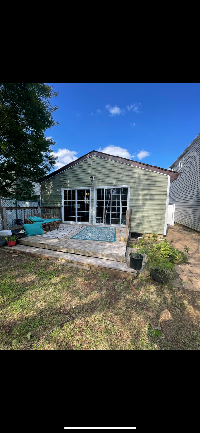The backyard of a house with a patio and a pool.