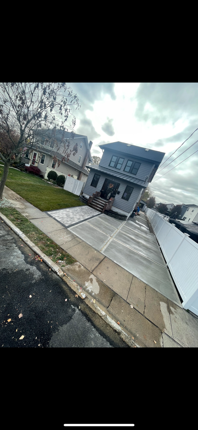 A house is sitting on its side on the side of the road.