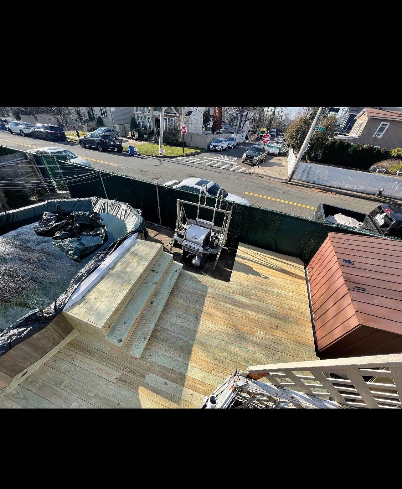 An aerial view of a wooden deck being built on top of a house.