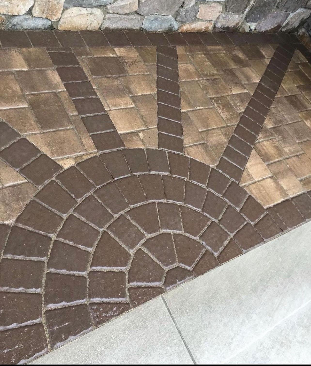 A brick walkway with a circular design on it