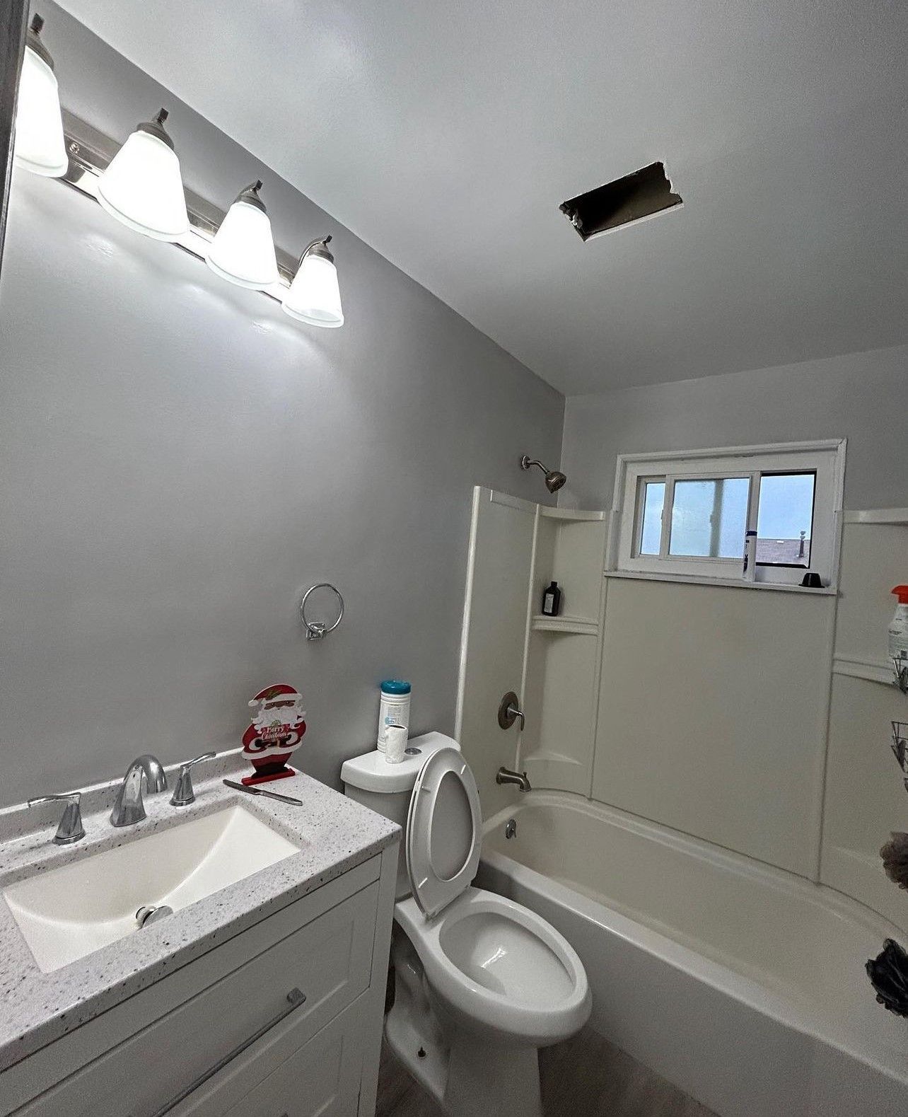 A bathroom with a toilet a sink and a bathtub