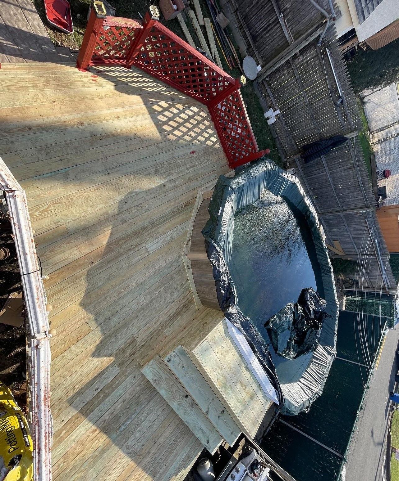 A boat is sitting on top of a wooden deck.