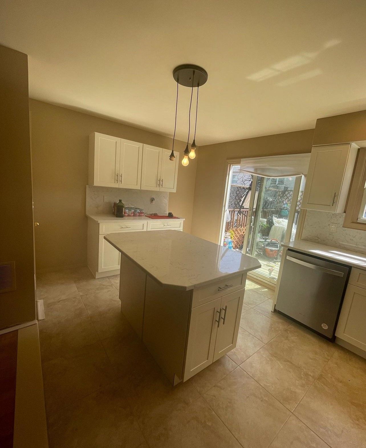 A kitchen with a large island in the middle of it.