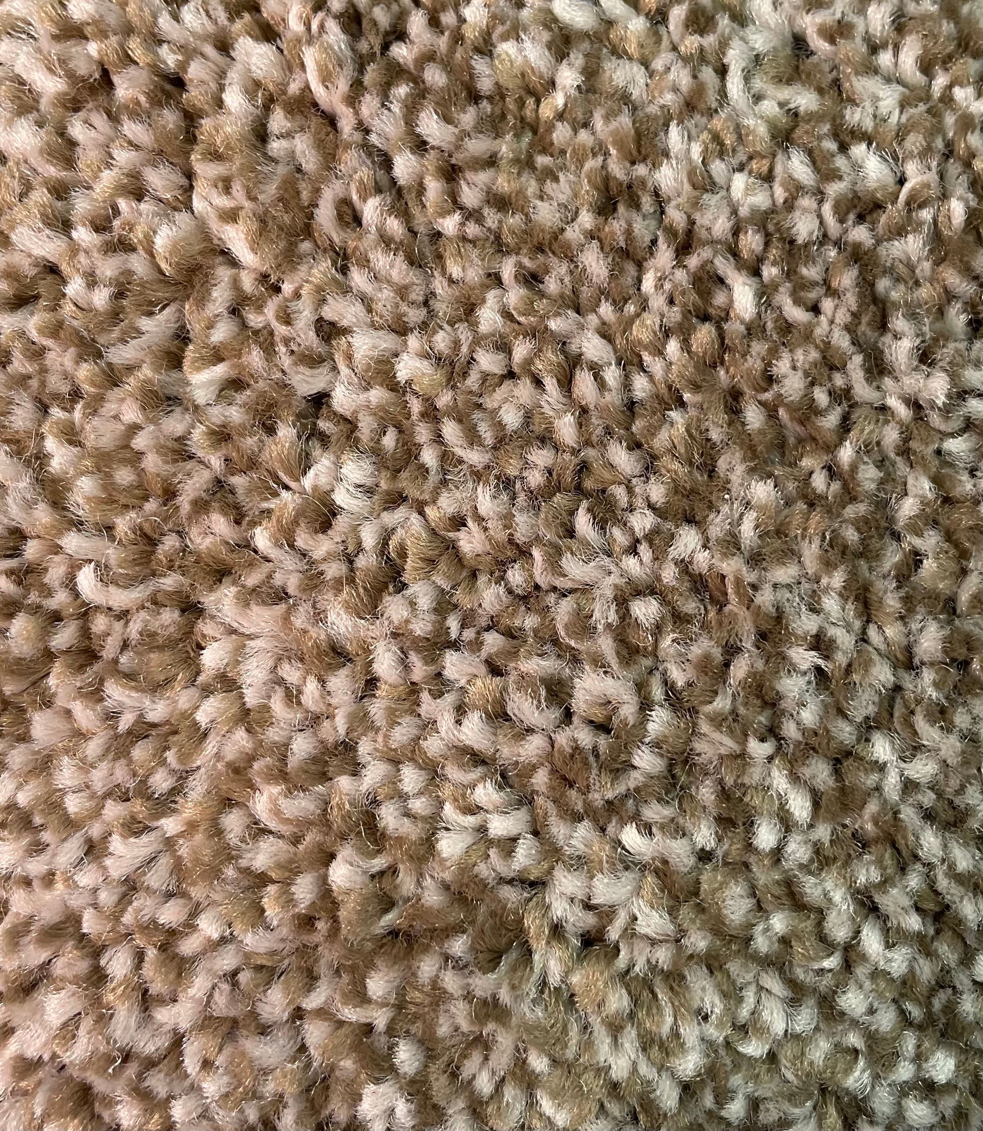 A close up of a pile of brown carpet.
