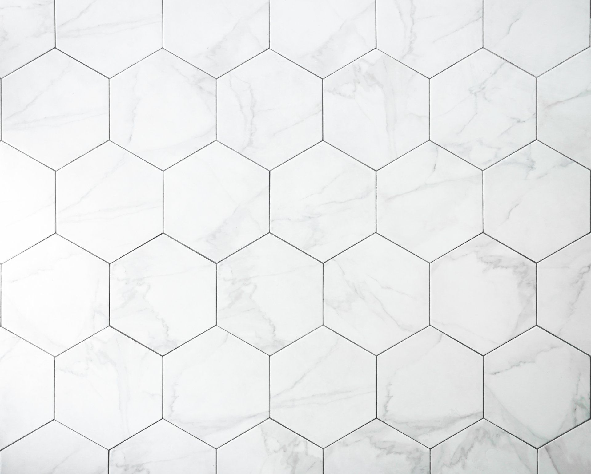 A close up of a white hexagon tile floor.