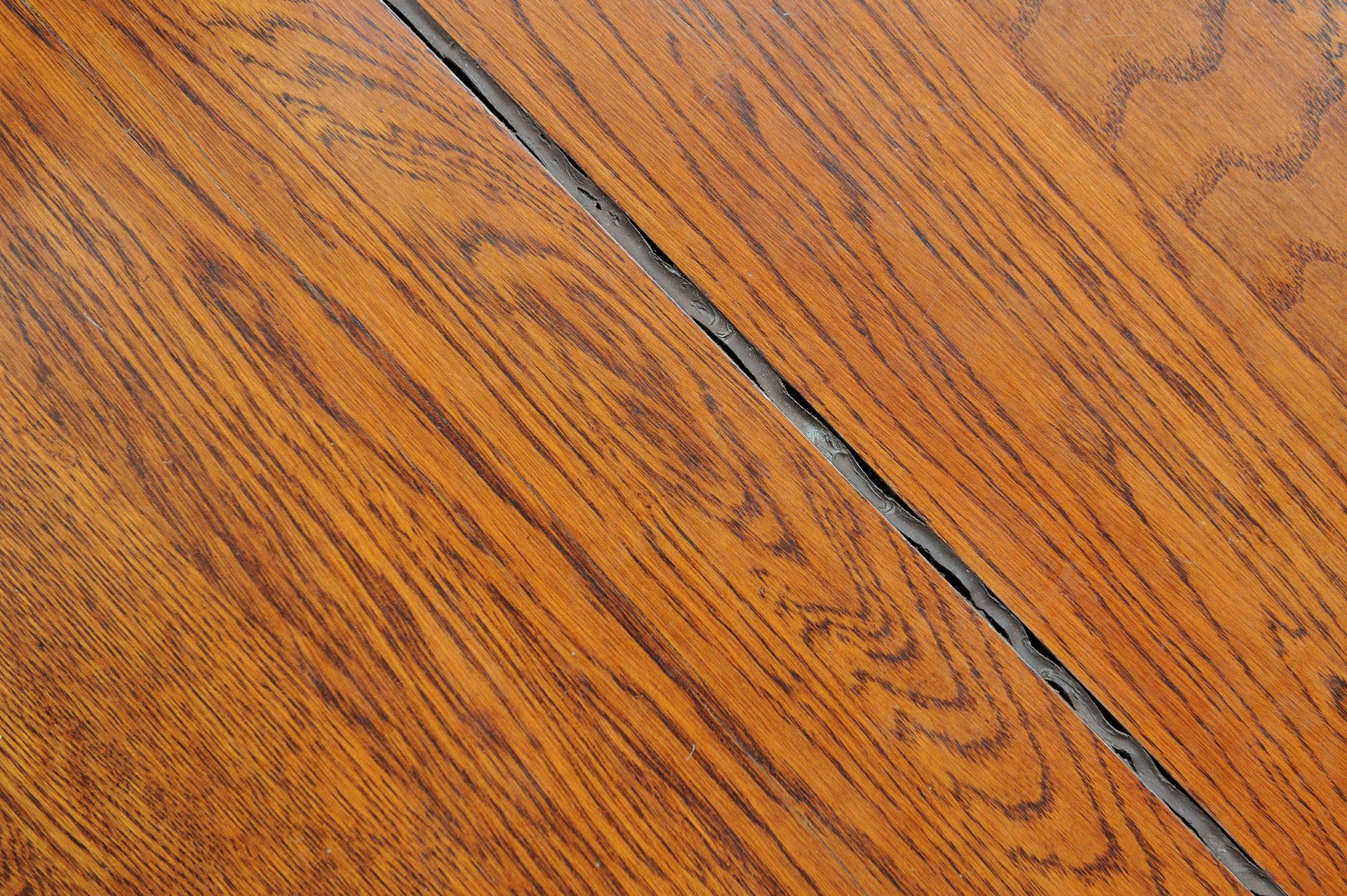 A close up of a wooden surface with a diagonal line