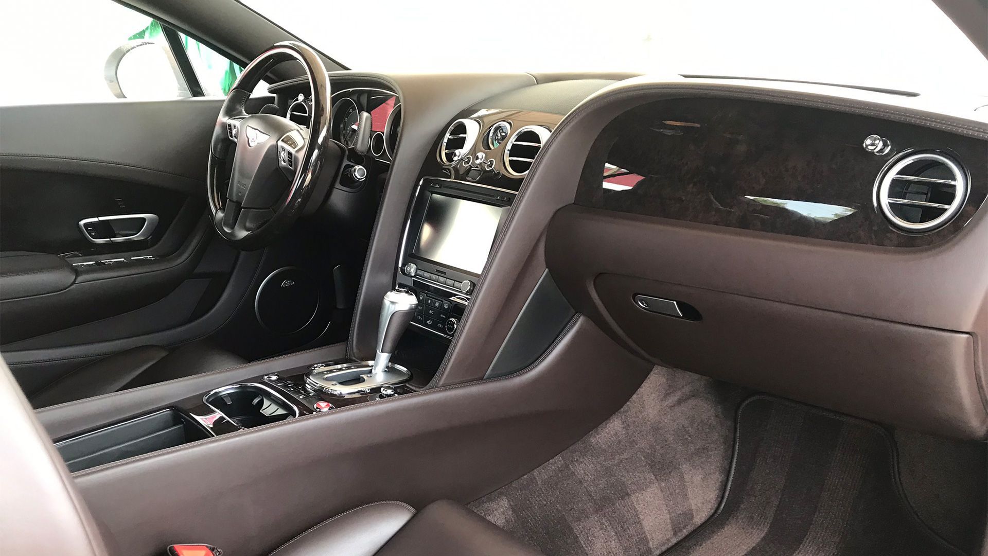 A group of men are posing for a picture in a garage.