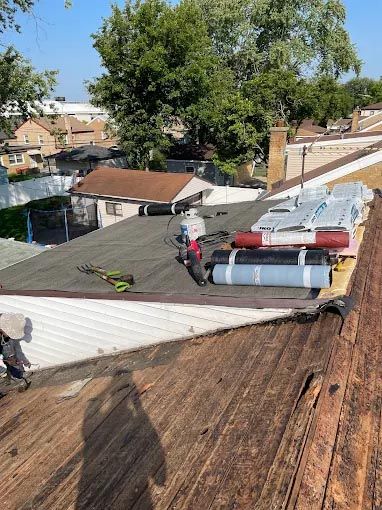 A person is working on the roof of a house.