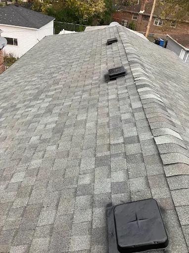 A roof with a lot of shingles and vents on it.