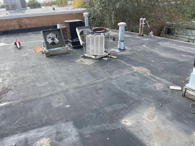 A roof with a lot of air conditioners on it.