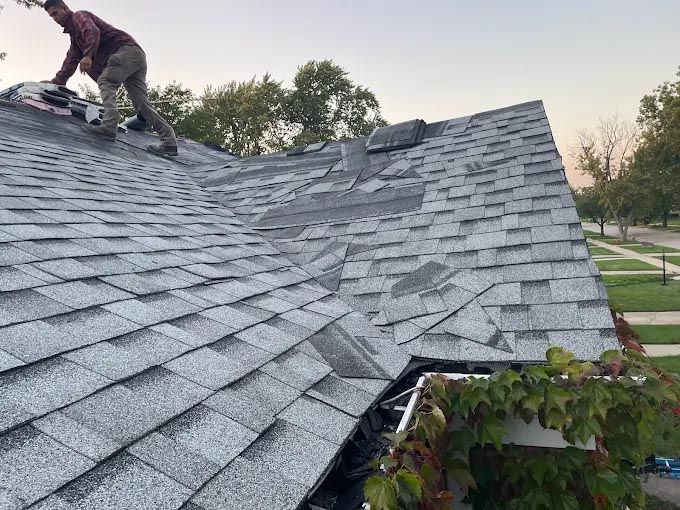 A man is working on the roof of a house.
