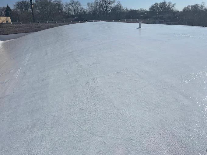 A person is skating on a white ice rink.