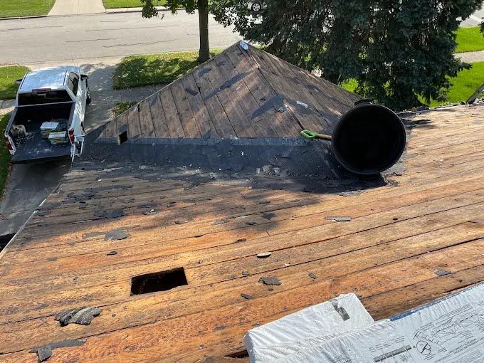 A truck is parked on the roof of a house.