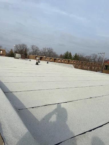 A white roof with a shadow of a person on it.