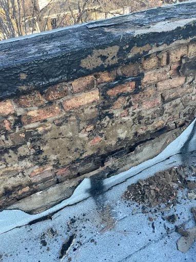 A brick wall is sitting on top of a roof.