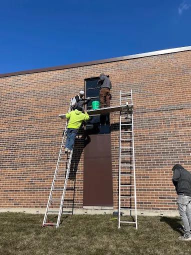 A white house with a window and a wooden roof.