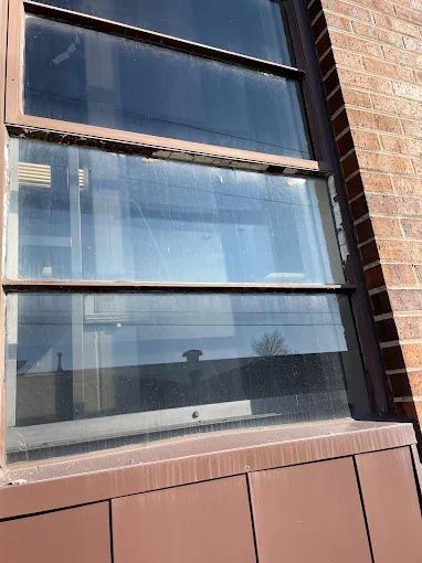 A close up of a window on a brick building.