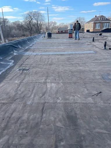 A man is walking on the roof of a building.