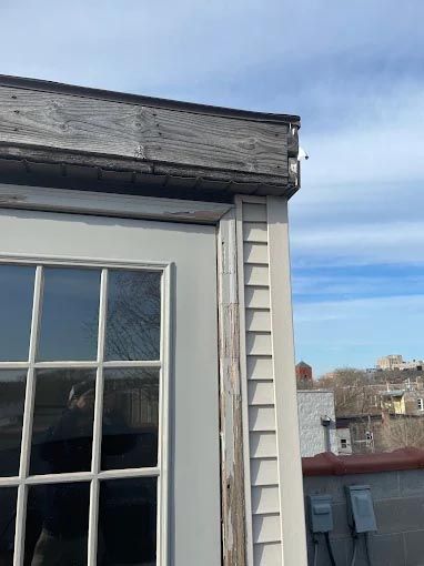 A white door with a window on the side of a building.