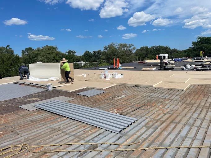 A man is carrying a box on top of a roof.
