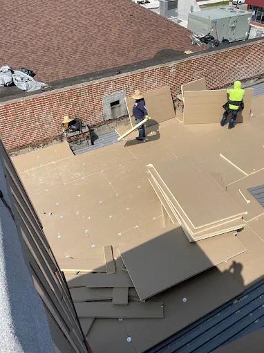 A group of people are working on a roof.