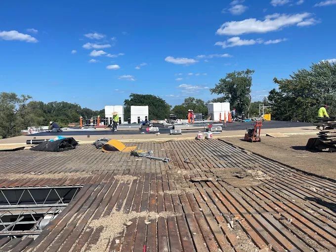 A roof is being repaired on a sunny day.