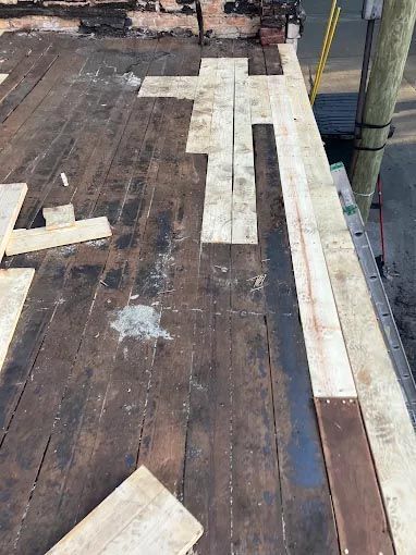 A wooden deck is being built on top of a building.