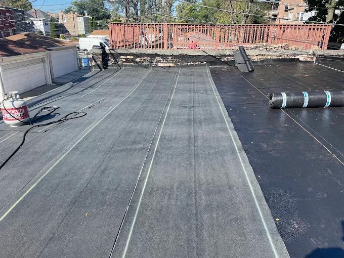 A white house with a window and a wooden roof.