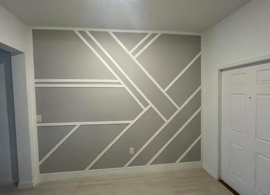 A room with a geometric pattern on the wall.