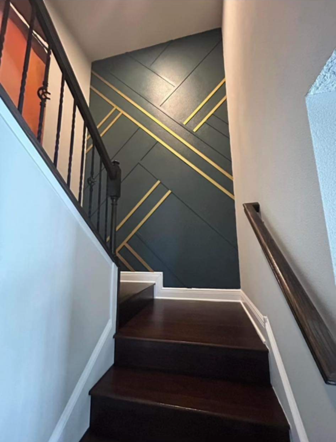 A staircase with a geometric design on the wall
