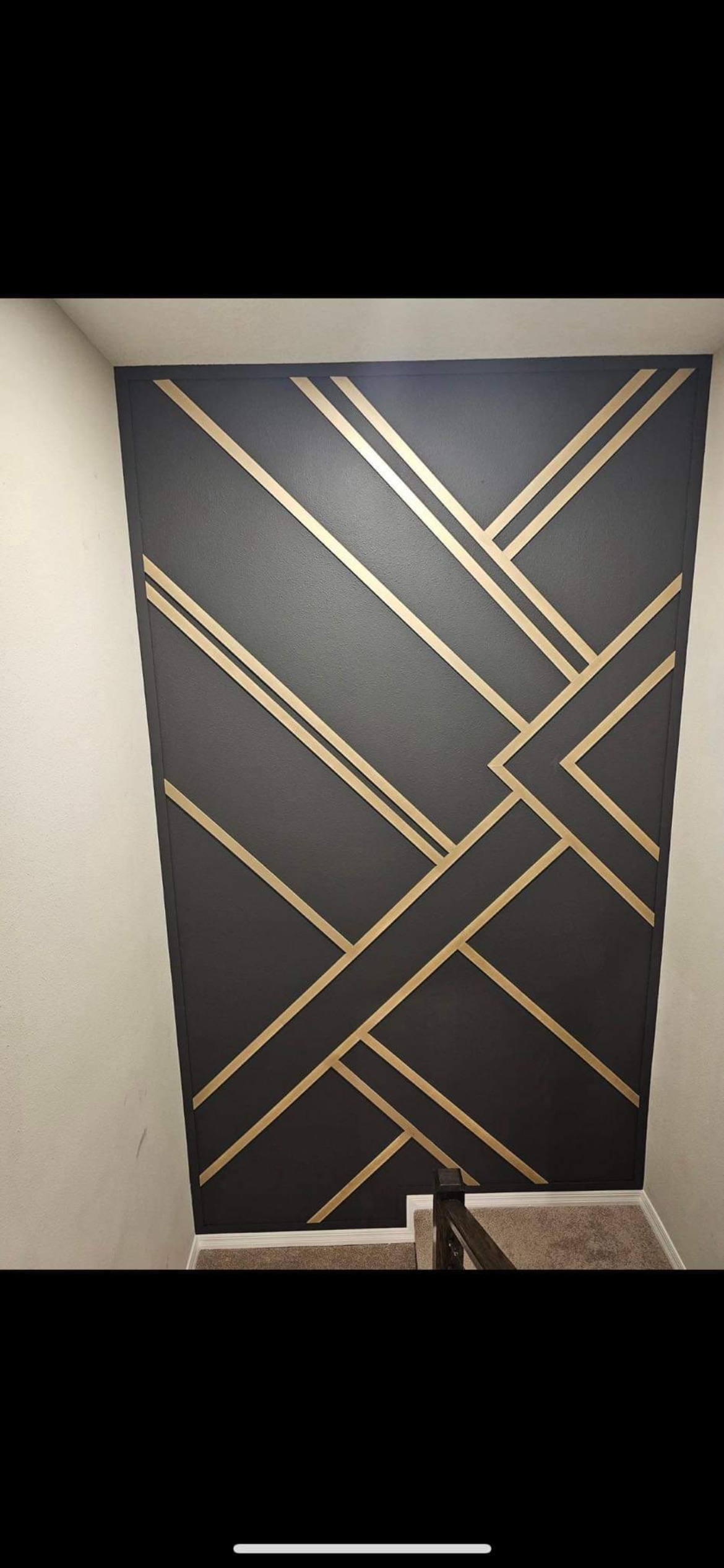 A wall with a geometric pattern painted on it.