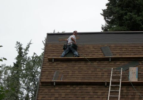 Man working on roof installation