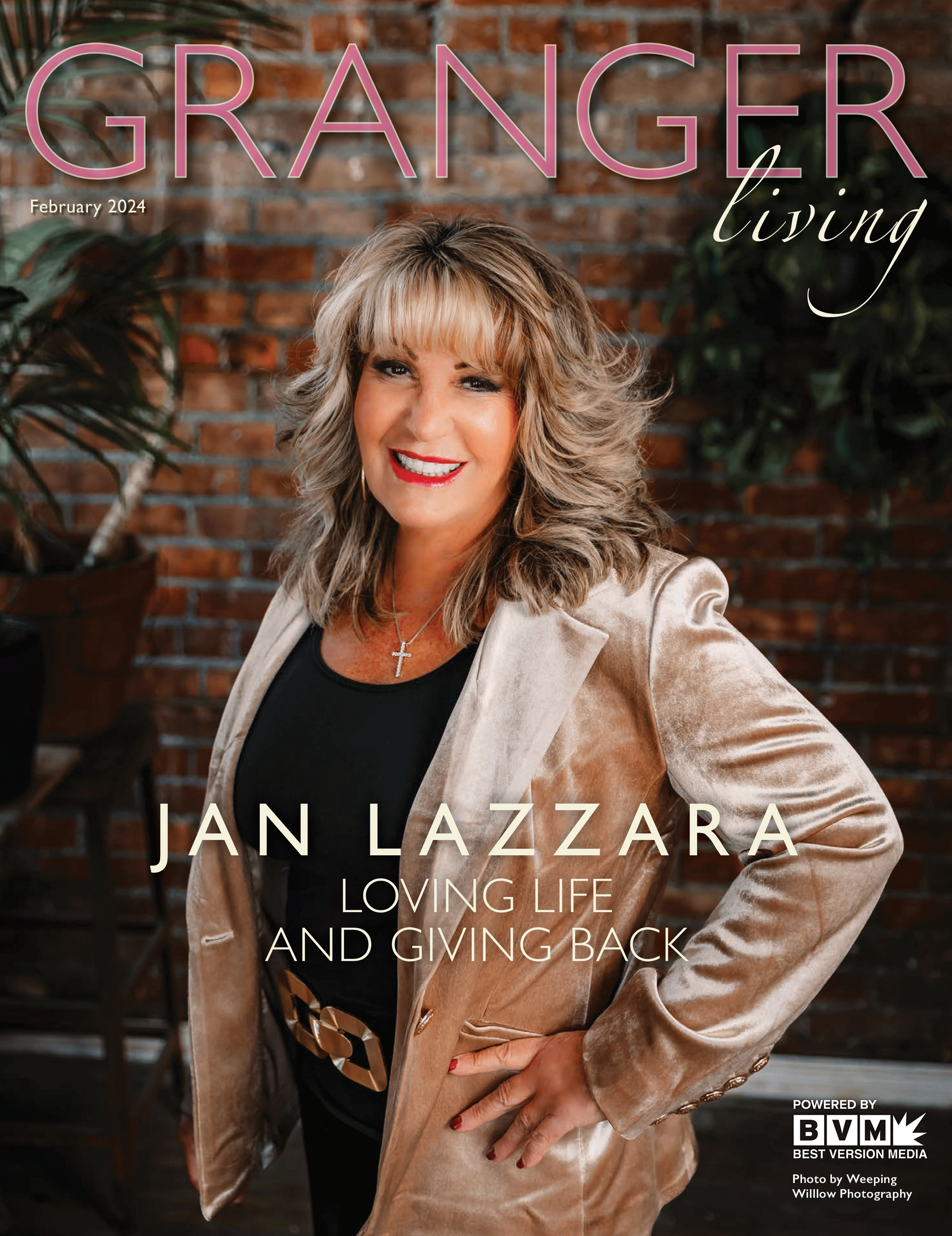 Jan Lazzara standing in front of a brick wall on the cover of a magazine.