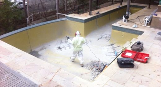 Concrete being renovated on by professional resurfacing technician