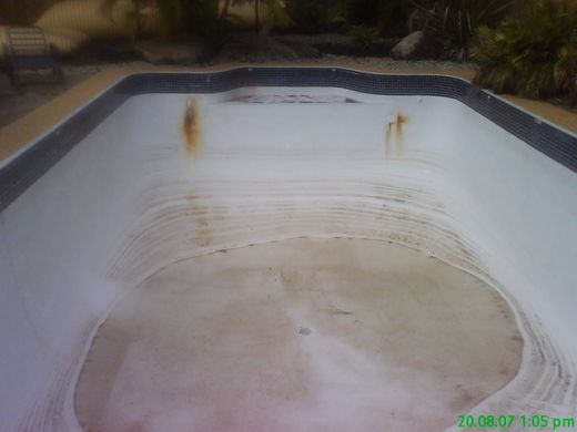 View of the rusted and discoloured pool to be renovated