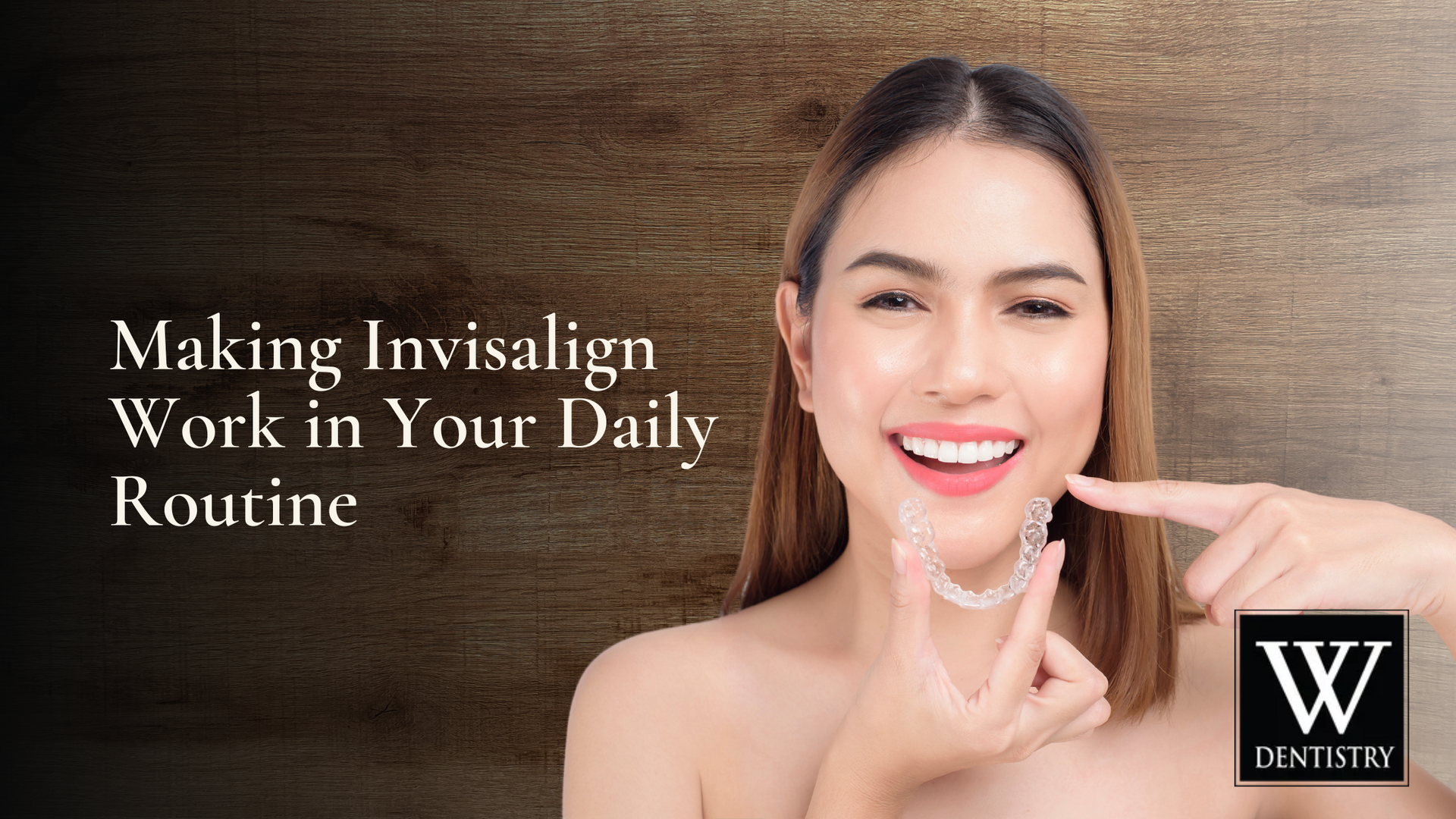 A woman is smiling and pointing at her teeth.