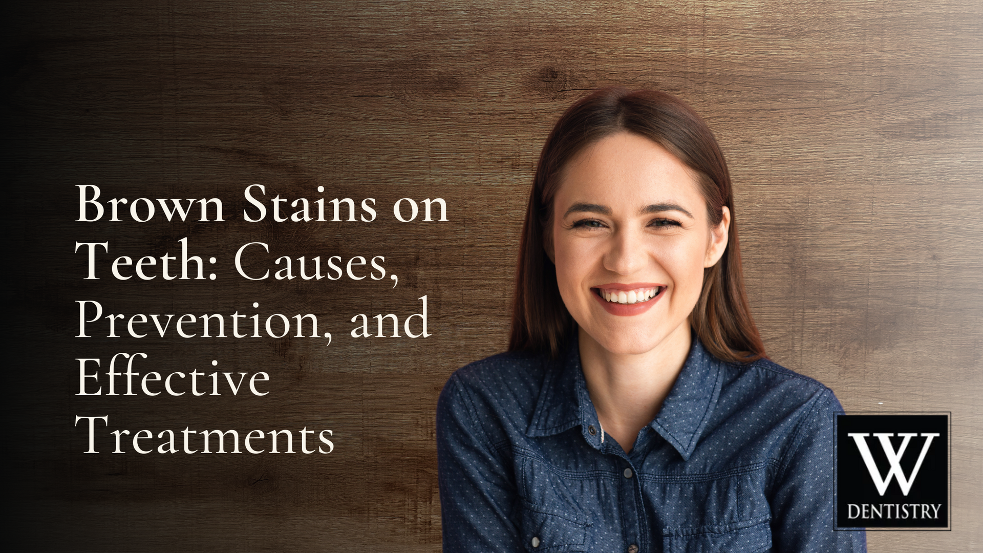 A woman is smiling in front of a wooden wall.