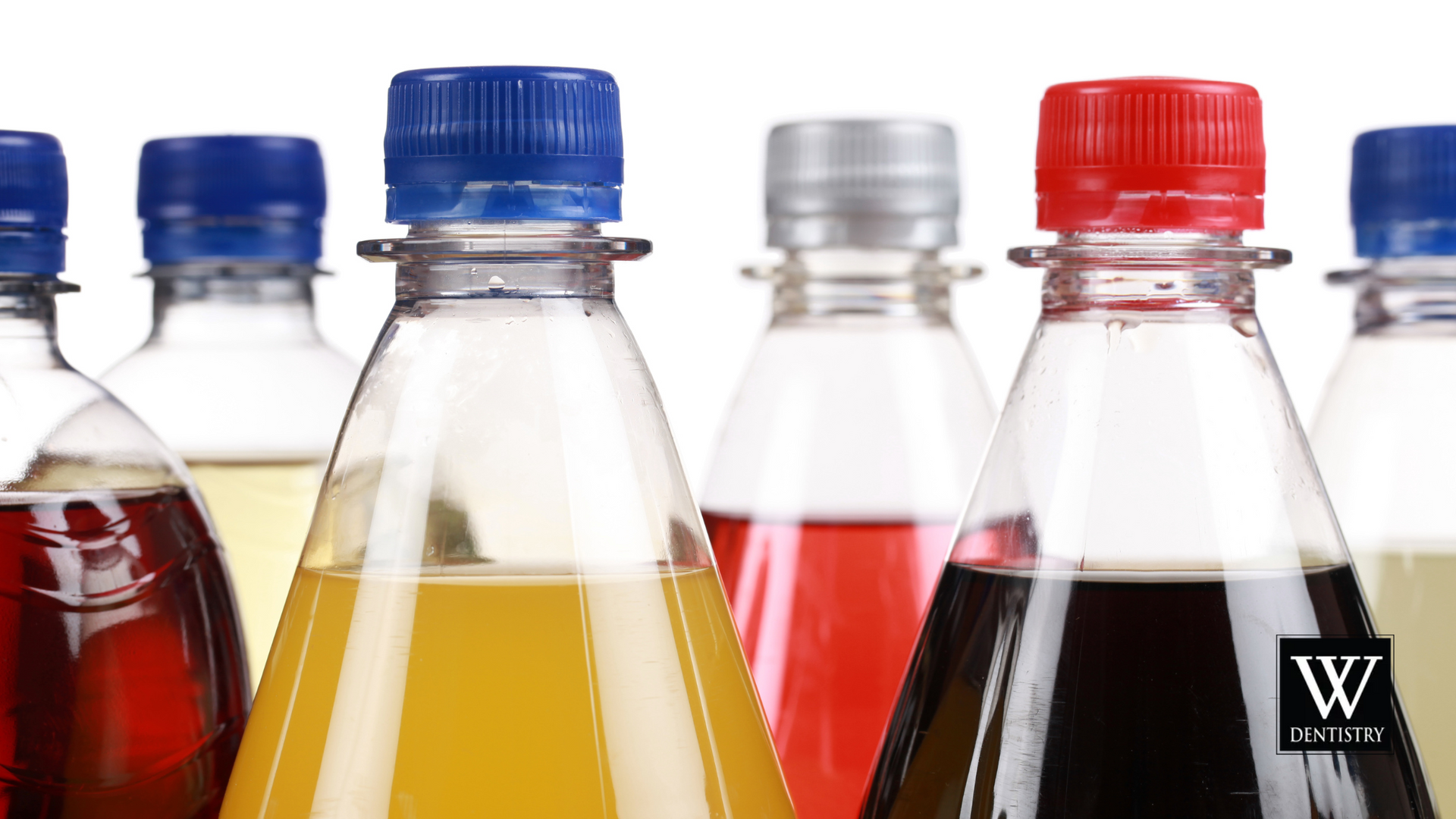 Several bottles of soda are lined up in a row