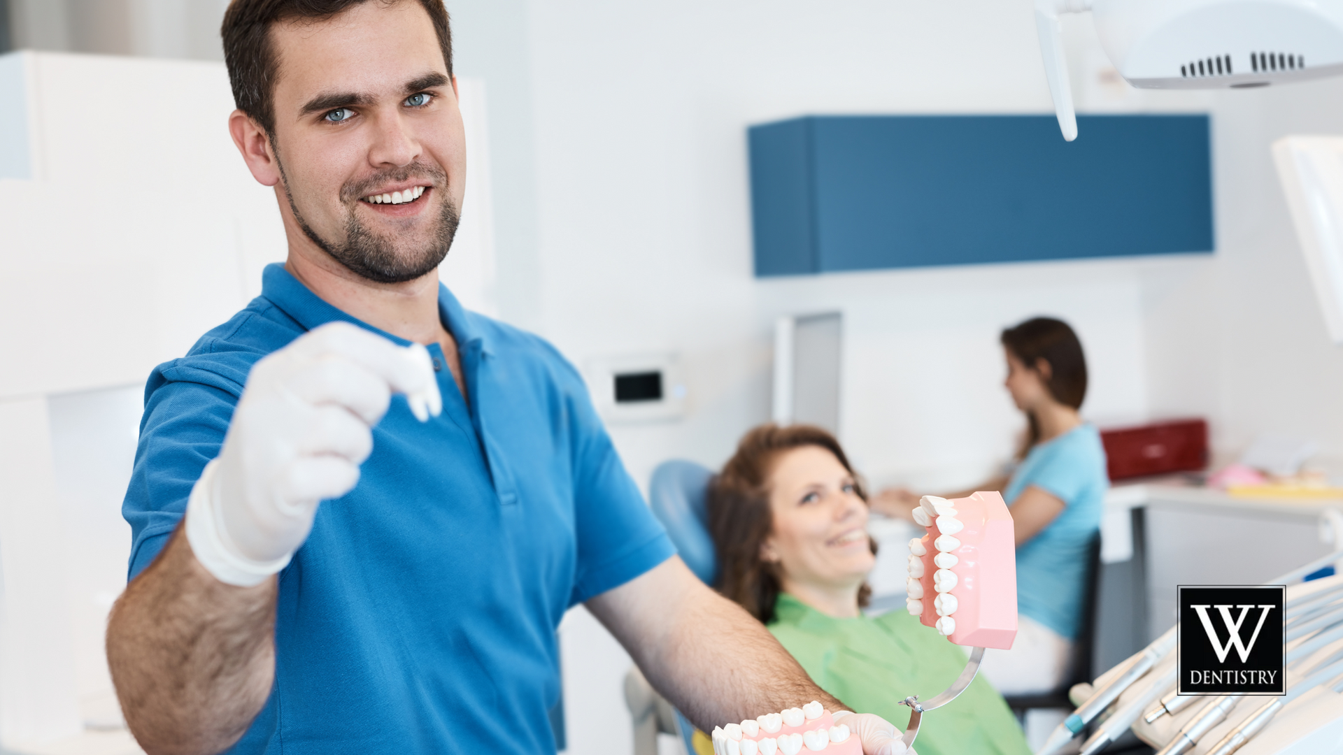 A dentist is holding a model of a patient 's teeth in a dental office.