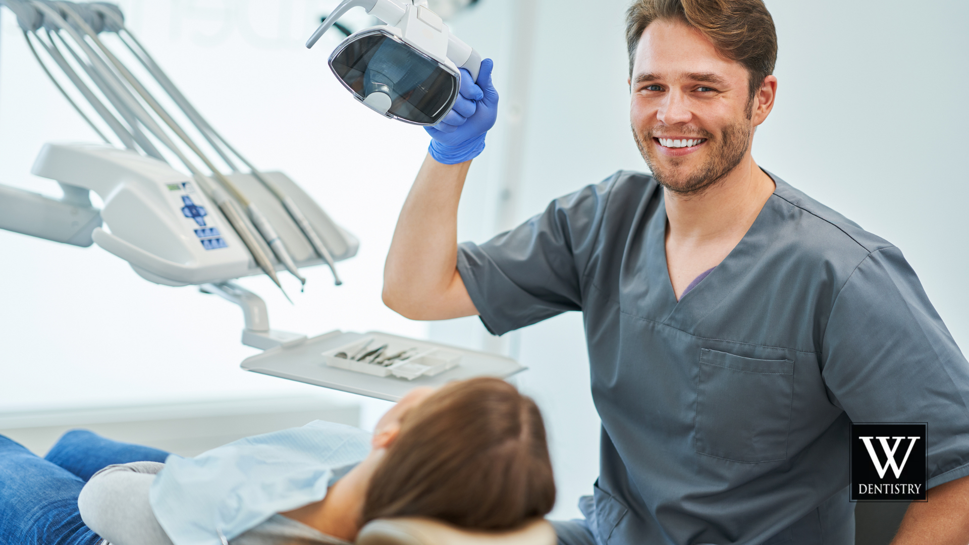 A dentist is giving a patient an x-ray in a dental office.