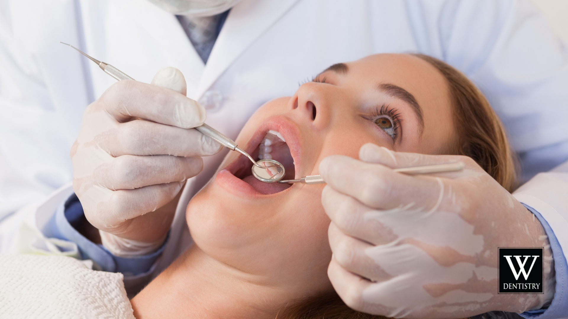 Woman at the dentist. Dentist examines her teeth with tools. White coat, gloves.