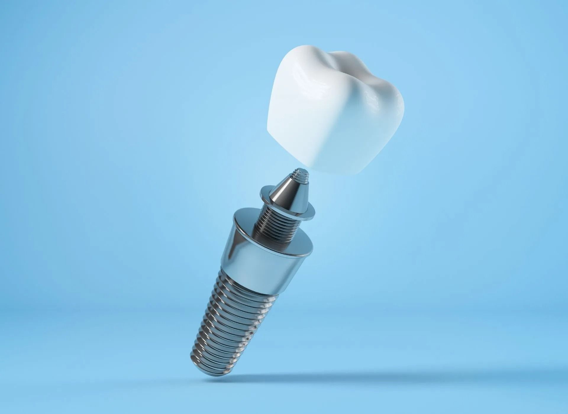 Dental implant with crown isolated on a light blue background