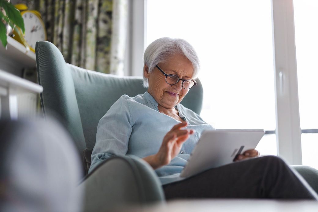 Senior woman using a digital tablet at home