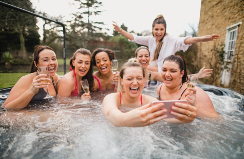 Team using spa sled equipment to slide hot tub safely
