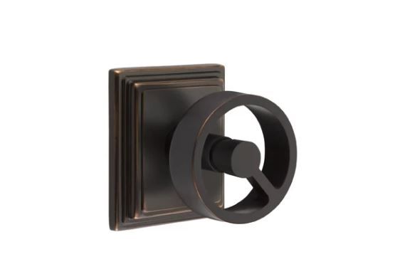 Bronze-colored, industrial-style cabinet knob with a square backplate and a round, wheel-shaped handle.