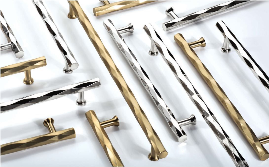 Various metal door handles, silver and gold, with textured, hammered designs.
