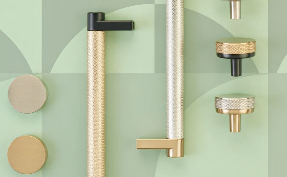 Hardware display: gold and black cabinet pulls and knobs against a green geometric backdrop.