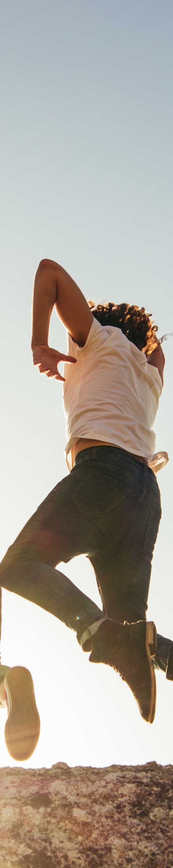 Person jumps in the air; outdoor setting.