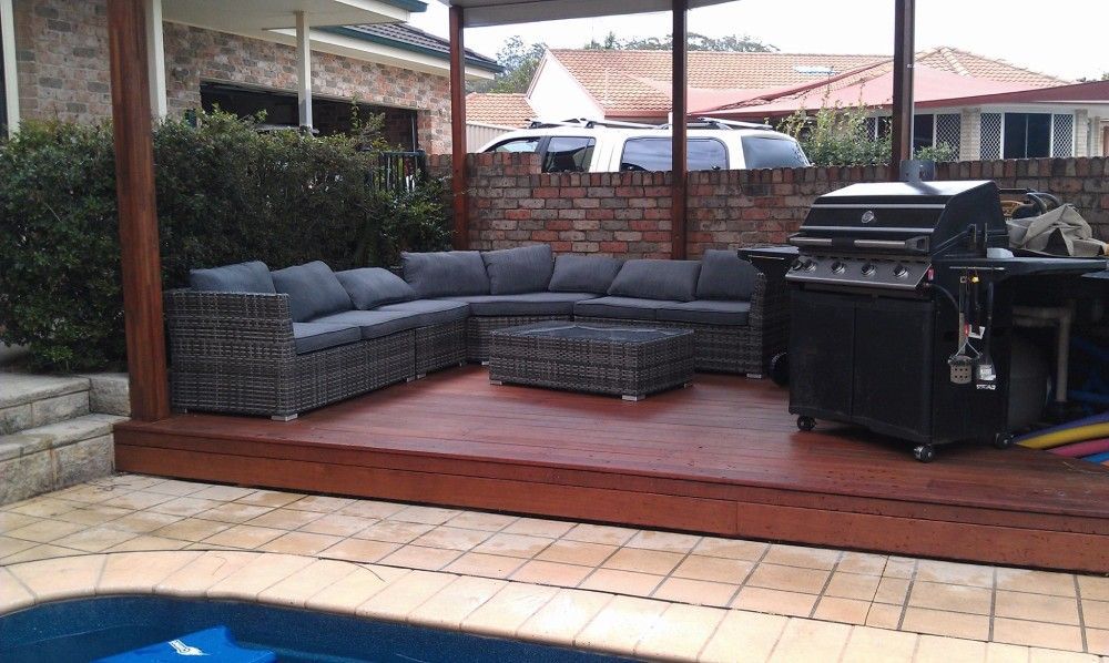 A Large Sectional Couch Sits On A Deck Next To A Grill — Boambee Home Improvements in Urunga, NSW