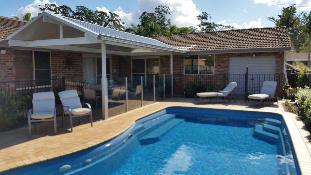 A House With A Swimming Pool In Front Of It — Boambee Home Improvements in Nambucca Heads, NSW